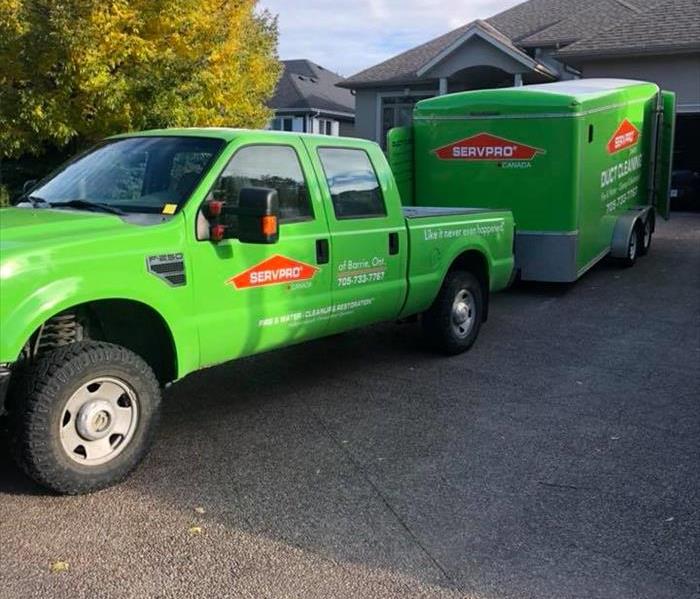 SERVPRO of Barrie's business truck and trailer in a local home's driveway while we perform repair work inside.